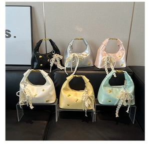 Detail view of colorful hobo bags with metallic finish and lace pearl heart charms