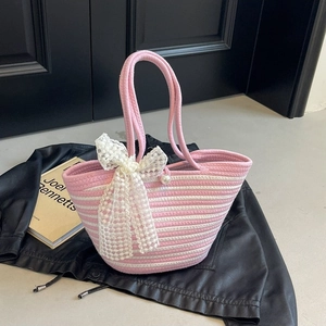 Pink and white striped woven tote bag with a large lace bow and pearl decoration