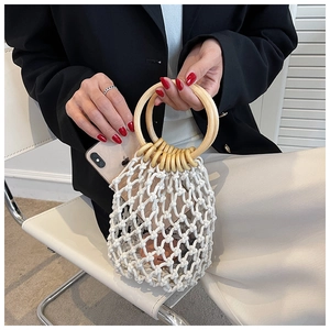 Detail of hand-woven white mesh bag with natural round wooden handles for summer