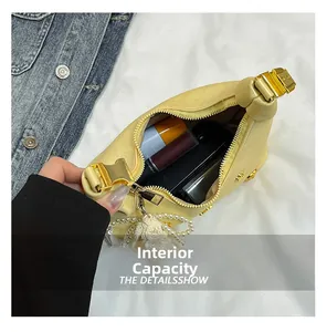 Top view of yellow handbag interior showing daily storage and pearl tassel detail