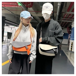 Street style shot of contrast color messenger bags with flap buckle and adjustable straps