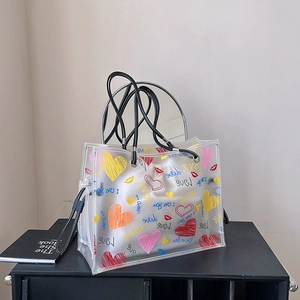 Transparent PVC tote bag with colorful heart prints and inner drawstring pouch