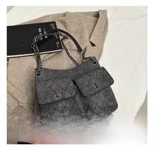 Detail shot of the vintage grey quilted shoulder bag with metal chain strap and twist locks