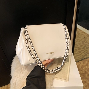 Retro cream chain shoulder bag with glossy leather and woven metal strap on display