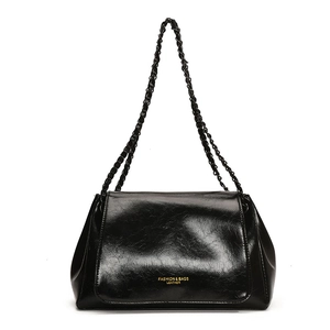 Classic black glossy leather shoulder bag with gold chain strap and stylish lettering
