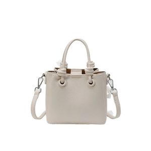 Chic beige lychee grain leather handbag with stylish knot handles and crossbody strap
