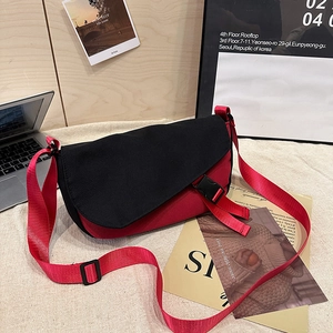 Red and black canvas messenger bag with adjustable strap and buckle for casual daily use