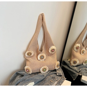 Detail of beige knit shoulder bag with 3D white daisy flowers and colorful bead accents