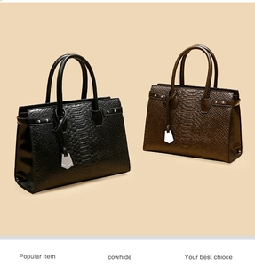 Detail of crocodile embossed leather texture on black and coffee cowhide handbags