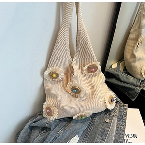 Detailed close-up of beige knitted hobo bag featuring colorful 3D beaded sunflower appliques