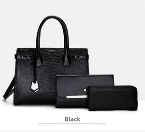 Detailed set of 3 black crocodile pattern leather handbags with metal pendant hardware