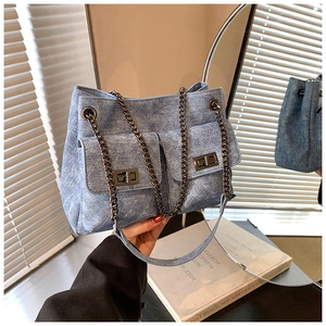 Blue denim quilted shoulder bag with metal chain strap and dual front pockets