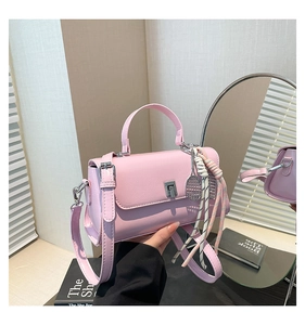 Pink lychee grain leather handbag with tennis racket charm and silver twist lock detail