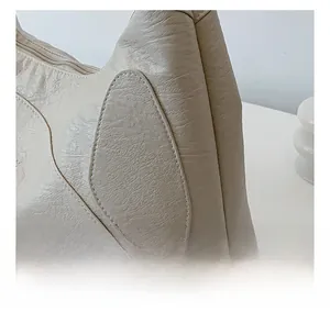 Detailed view of the fine texture and neat stitching on this cream white nylon tote bag