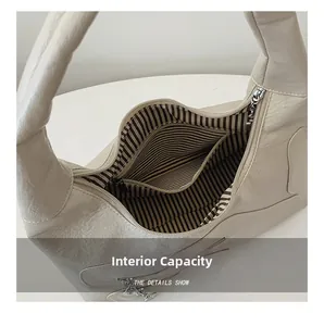 Detail view of large tote interior with striped lining and secure zipper pocket