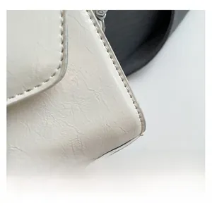 Detail view of cream-white bag featuring premium pleated texture and neat stitching
