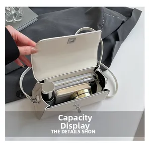 Interior view showing the capacity of the cream faux leather crossbody bag