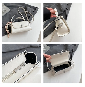 Detail view of white PU leather crossbody bag featuring twist lock and inner zipper