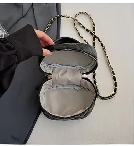 Macro view of the black quilted mini bag interior showing a neat inner pocket and lining