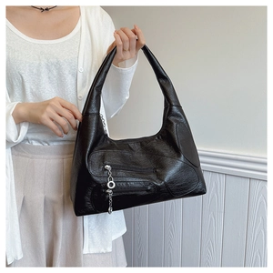 Detailed view of black retro nylon shoulder bag with silver chains and zip pockets