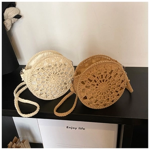 Detailed view of handmade straw crossbody bags with intricate radial crochet patterns