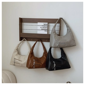 Detail of four chic nylon crescent shoulder bags in cream, brown, black and grey