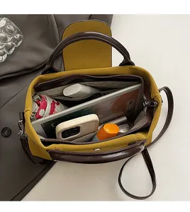 Top view of contrast color handbag interior showing spacious capacity for tablets and more