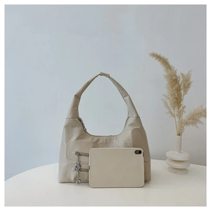 Size comparison of beige nylon shoulder bag with a tablet showing spacious interior