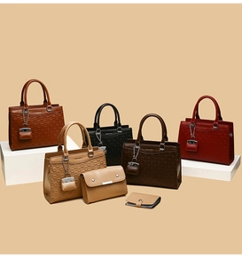Detail of multi-piece handbag set in five colors with geometric embossed pattern