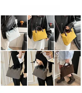 Detail view of contrast canvas tote bags in various colors with leather handles and flap