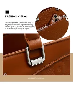 Close-up of geometric embossed caramel leather tote bag with silver metal ring and inner pocket