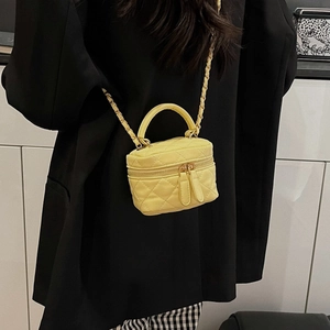 Mini yellow quilted leather crossbody bag with chain strap and gold double zippers