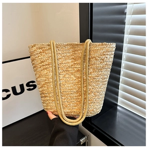 Macro detail of natural straw texture and woven rope handles on a beige tote bag