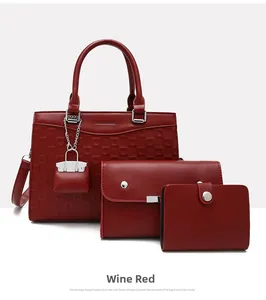 Three-piece red tote bag set with textured surface and metallic lock charm detail