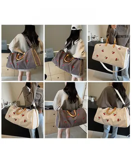 Detail shots of large canvas travel tote bag with cherry embroidery and yellow straps