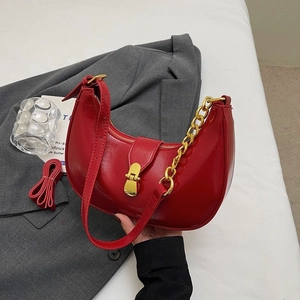 Minimalist red crescent hobo shoulder bag with gold chain and sleek polished finish
