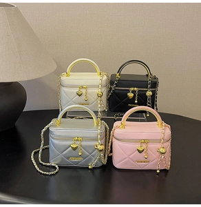 Detailed collection of four quilted handbags in white, black, silver and pink with chains