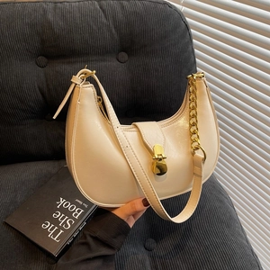 Minimalist cream crescent shoulder bag with golden chain and metallic buckle detail