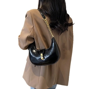 Minimalist black glossy leather crescent shoulder bag with golden chain and U-shape design
