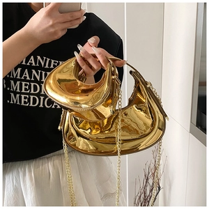 Detail of gold glossy crescent bags with chain straps in large and mini sizes
