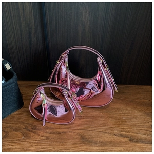 Macro detail of rose pink metallic glossy mini half-moon handbag set in two sizes
