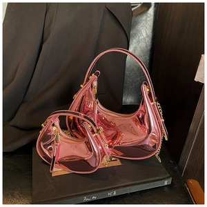 Detail of pink metallic patent leather mini crescent bags with gold zippers and chains