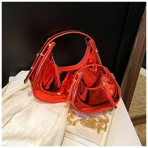Detail of red patent leather mini handbags set with metallic finish and gold chain