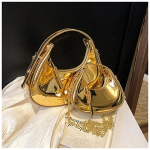 Detail of gold metallic semi-circle bags with glossy finish and metal chain straps