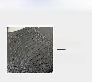 Detail view of crocodile and pebble grain leather stitching with pale gold hardware