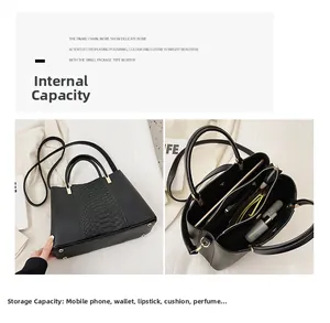 Close-up of black tote bag interior showing multi-layer compartments and large capacity