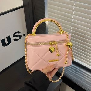 Pink quilted box handbag with gold circular handle and heart pendant chain strap