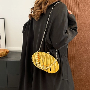 Elegant gold textured acrylic clutch with metal bead handle and crossbody chain