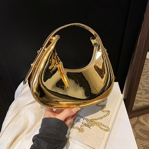Glossy gold metallic half-moon handbag with top handle and fine chain strap