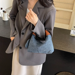 Blue tweed triangle handbag with brown leather handle styled on shoulder for women